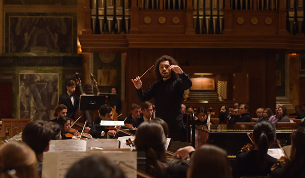 51̳U student conducting orchestra during performance at St. MAtthew's Cathedral in Washington, DC
